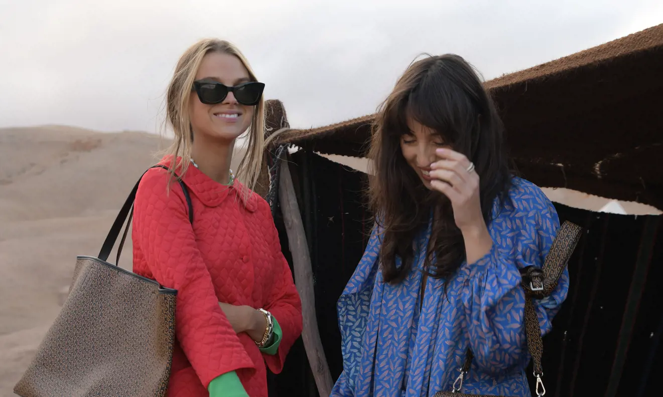 women by tent in desert