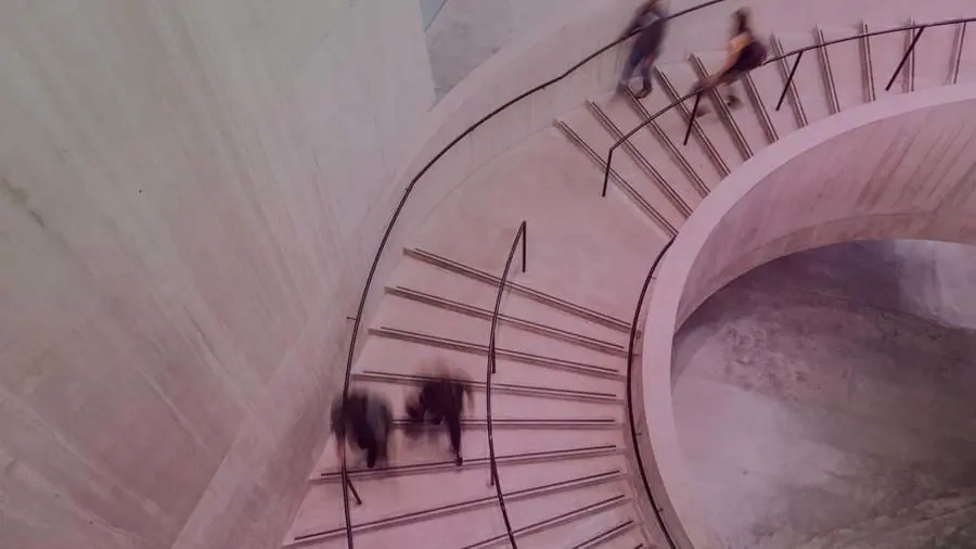 people moving quickly down a staircase