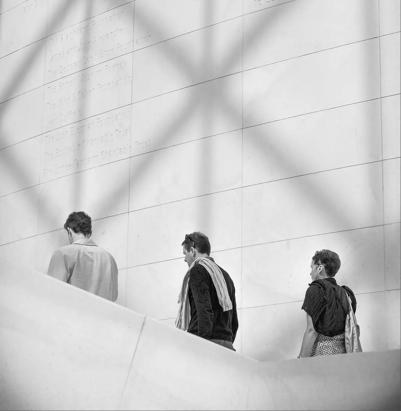 British Library Inside three people climbing the stares