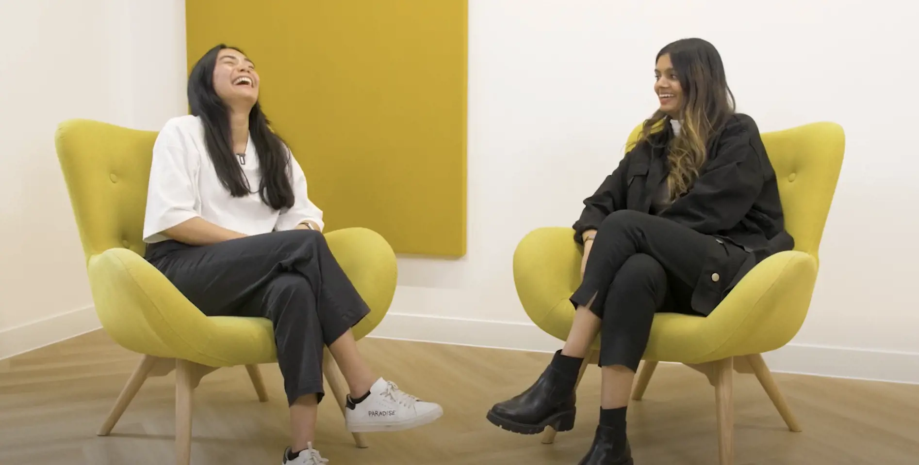 Two women laughing in an office