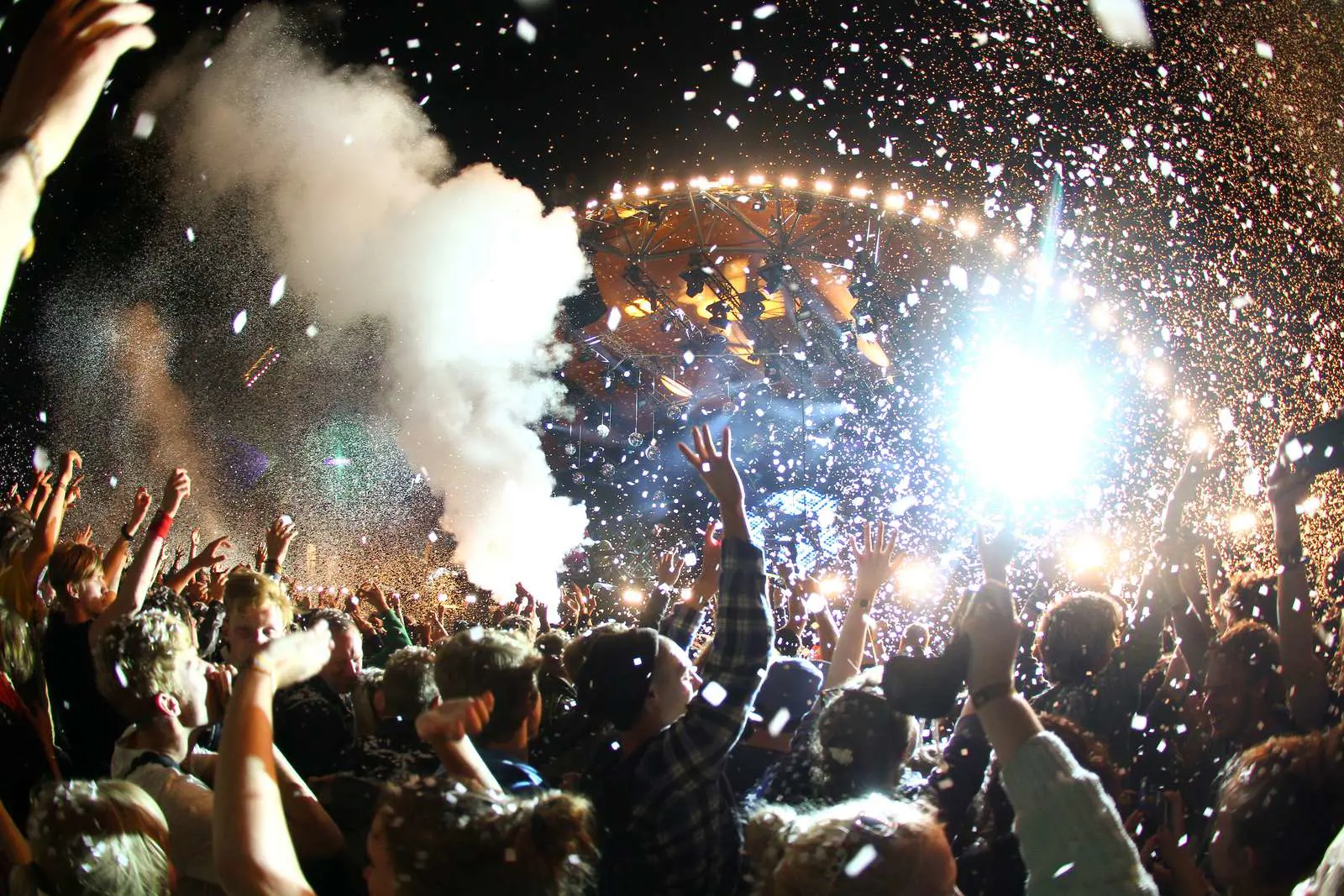 group of people with hands up on a music festival 