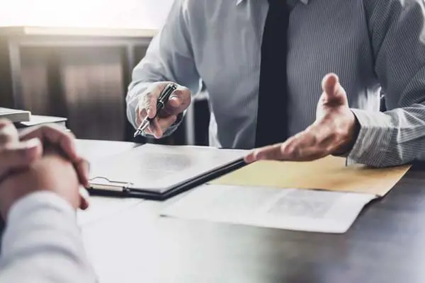 AGM Abogados men's hands next to papers at the table