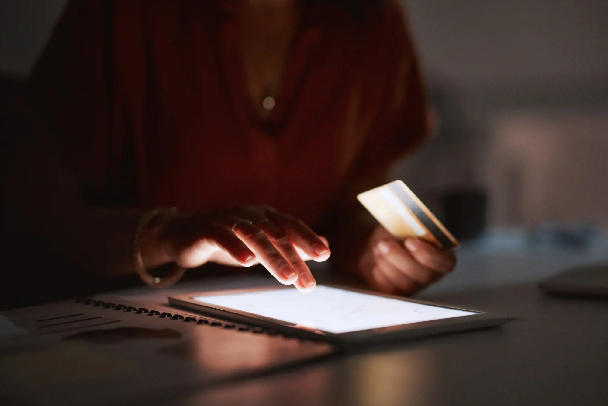 Person trykker på en tablet og holder kreditkort i hånden | Novicell, Digitalt konsulenthus
