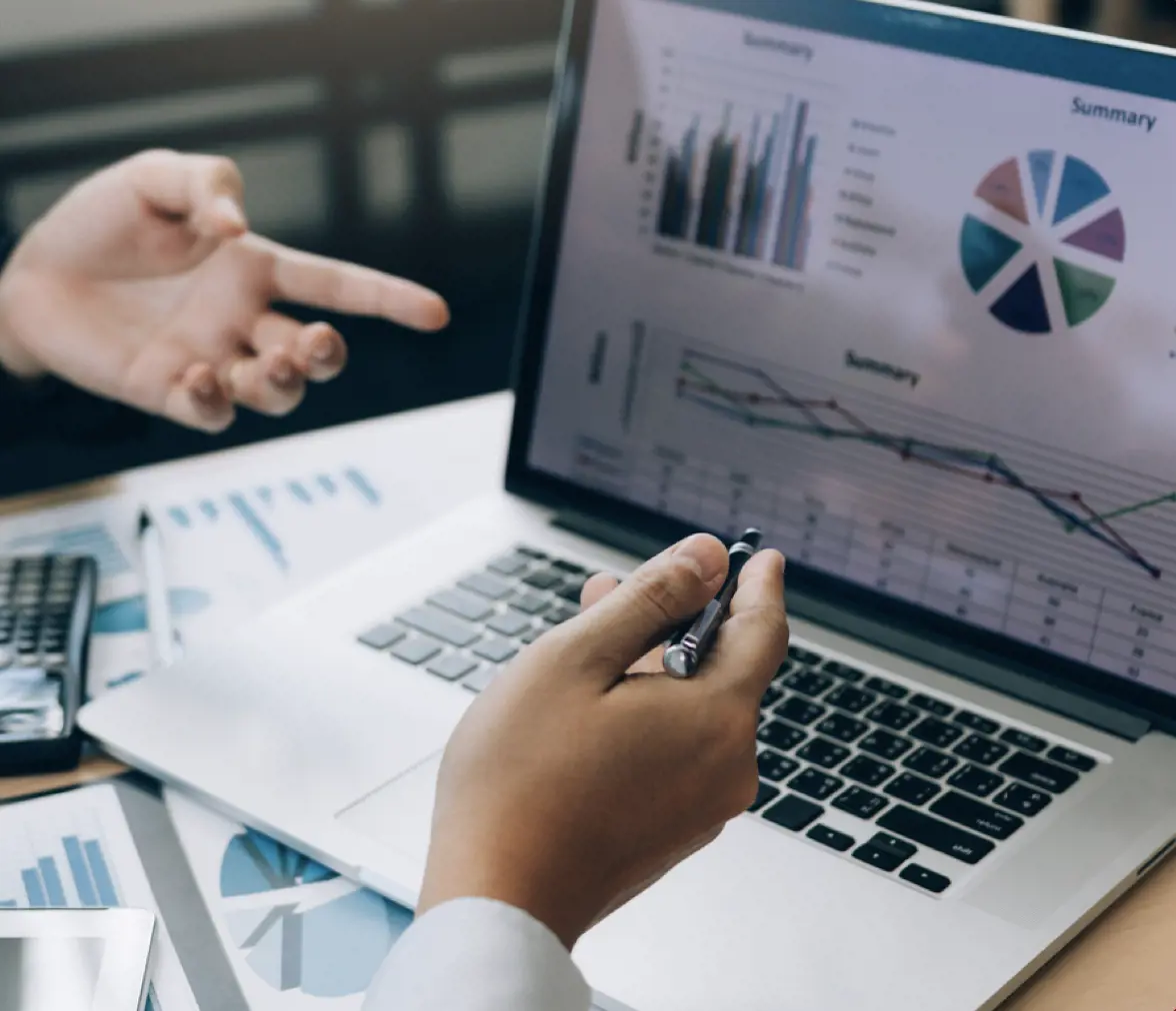 SEO expertise hands pointing out on a chart on a laptop